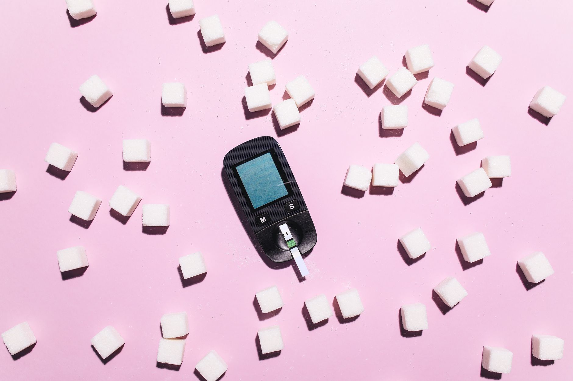 Continuous glucose monitor sensor on a person's arm with a glucose reading