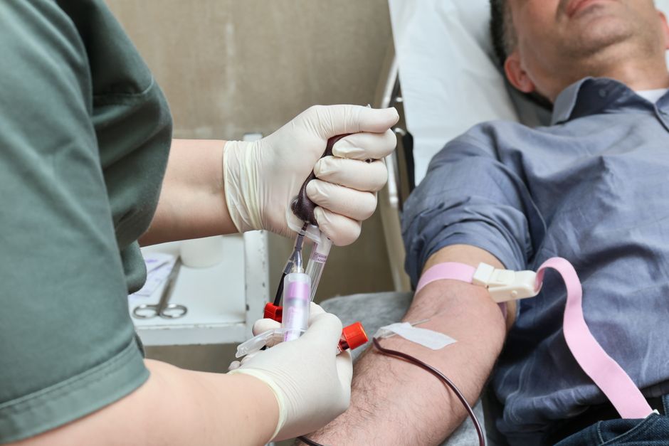 What Does a High GGT Blood Test Mean? Causes and Next Steps - phlebotomist drawing blood