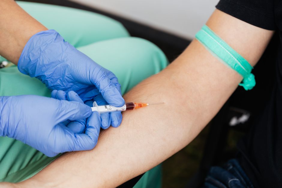 How to Read Blood Work Test Results: A Plain-English Guide to Your Lab - phlebotomist drawing blood
